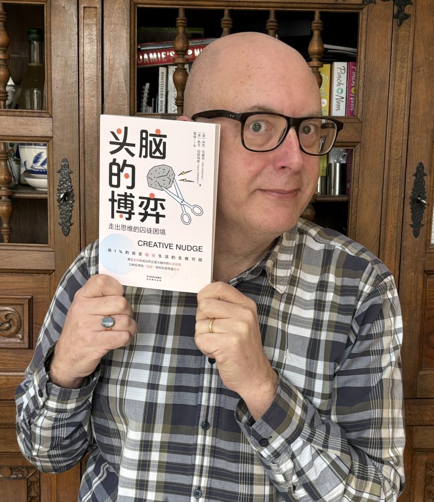 Kevin Chesters holding a copy of the Chinese edition of The Creative Nudge